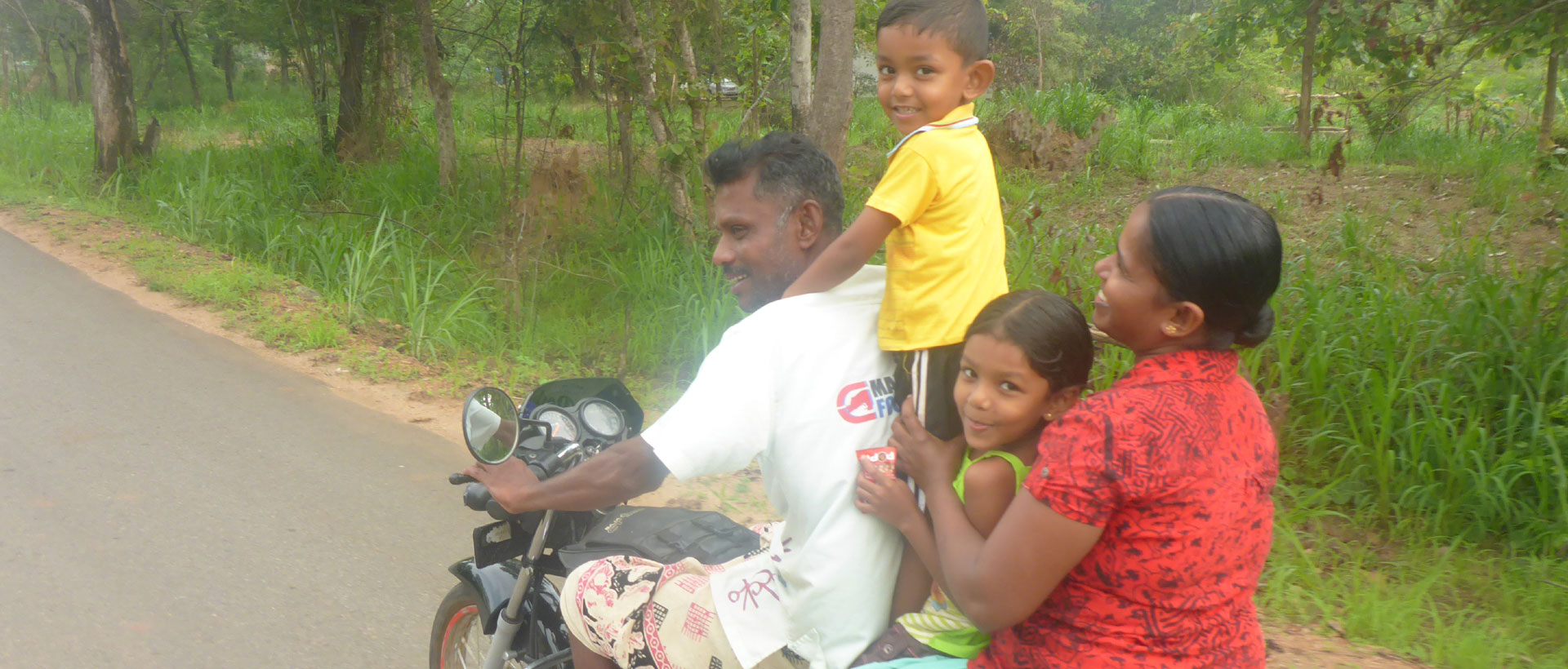 happy Sri Lankan family on Motor bike